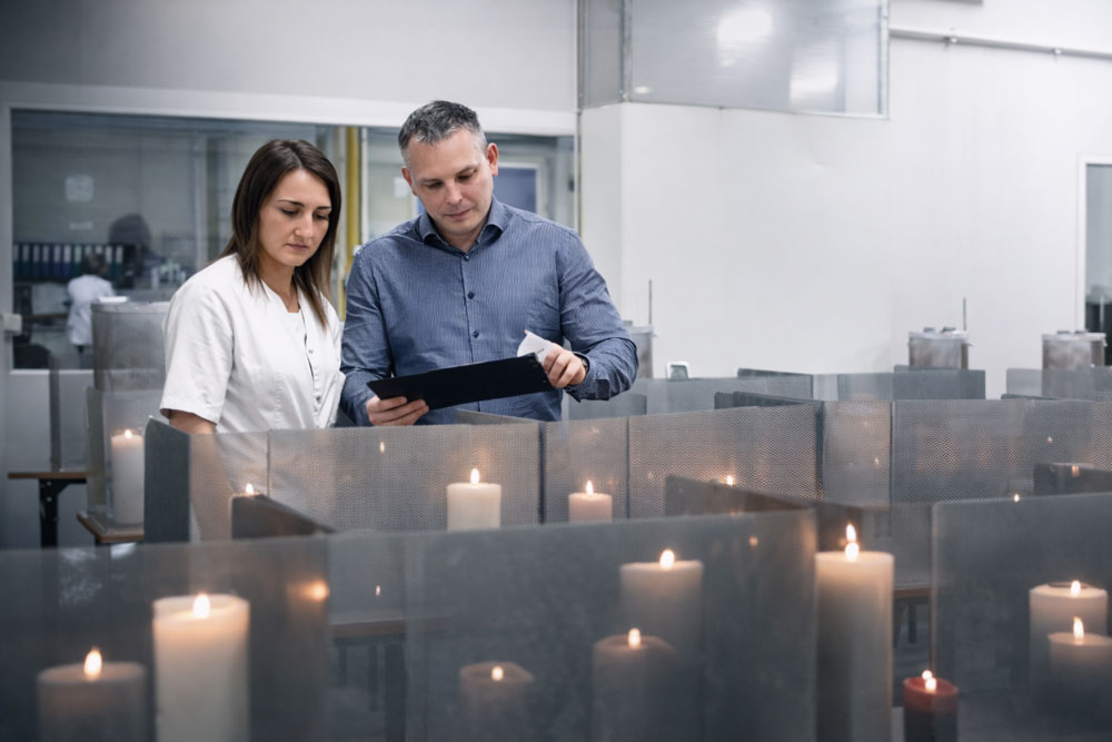 Employees document the burning behavior of candles