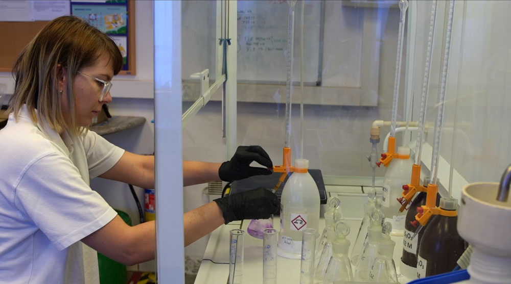 A chemist checks the composition of raw materials
