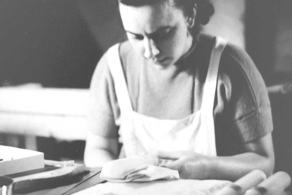 A worker involved in manual candle making