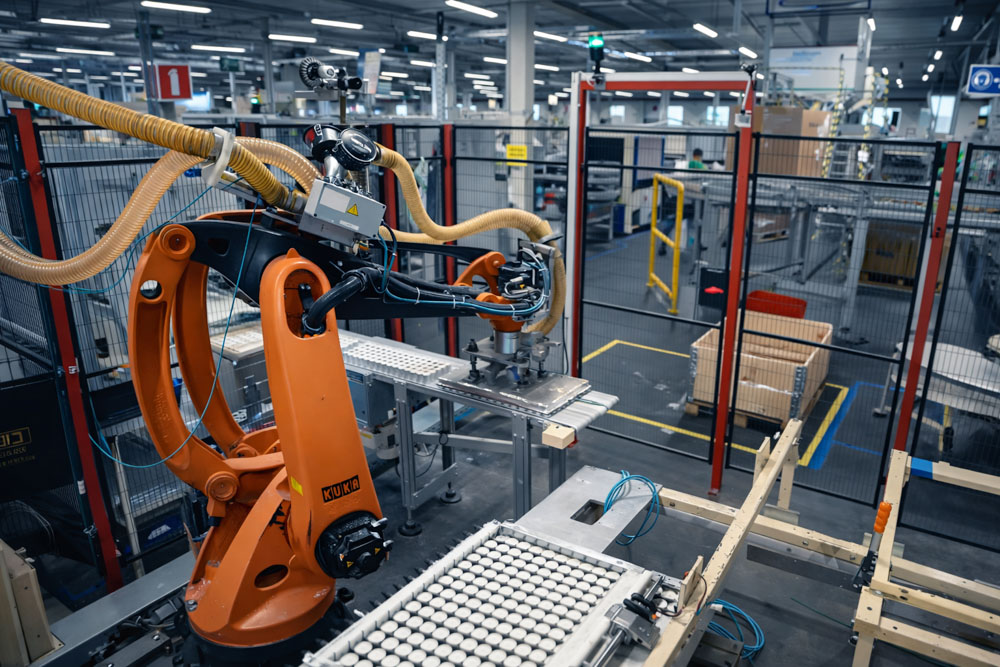 A robot arm in tea light production