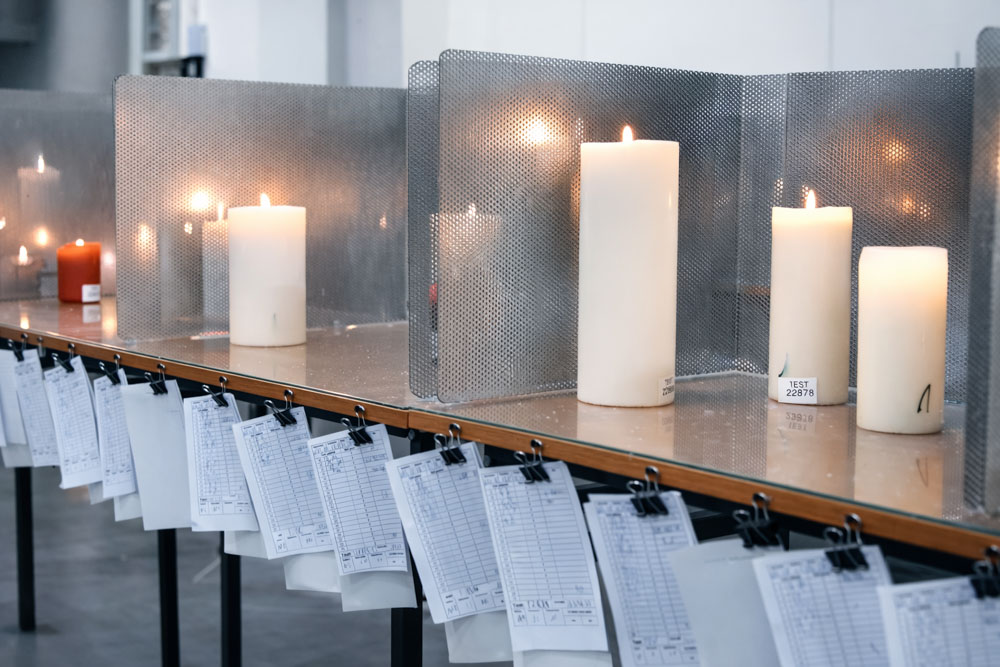 Candle burn tests are displayed on tables, along with the documentation.
